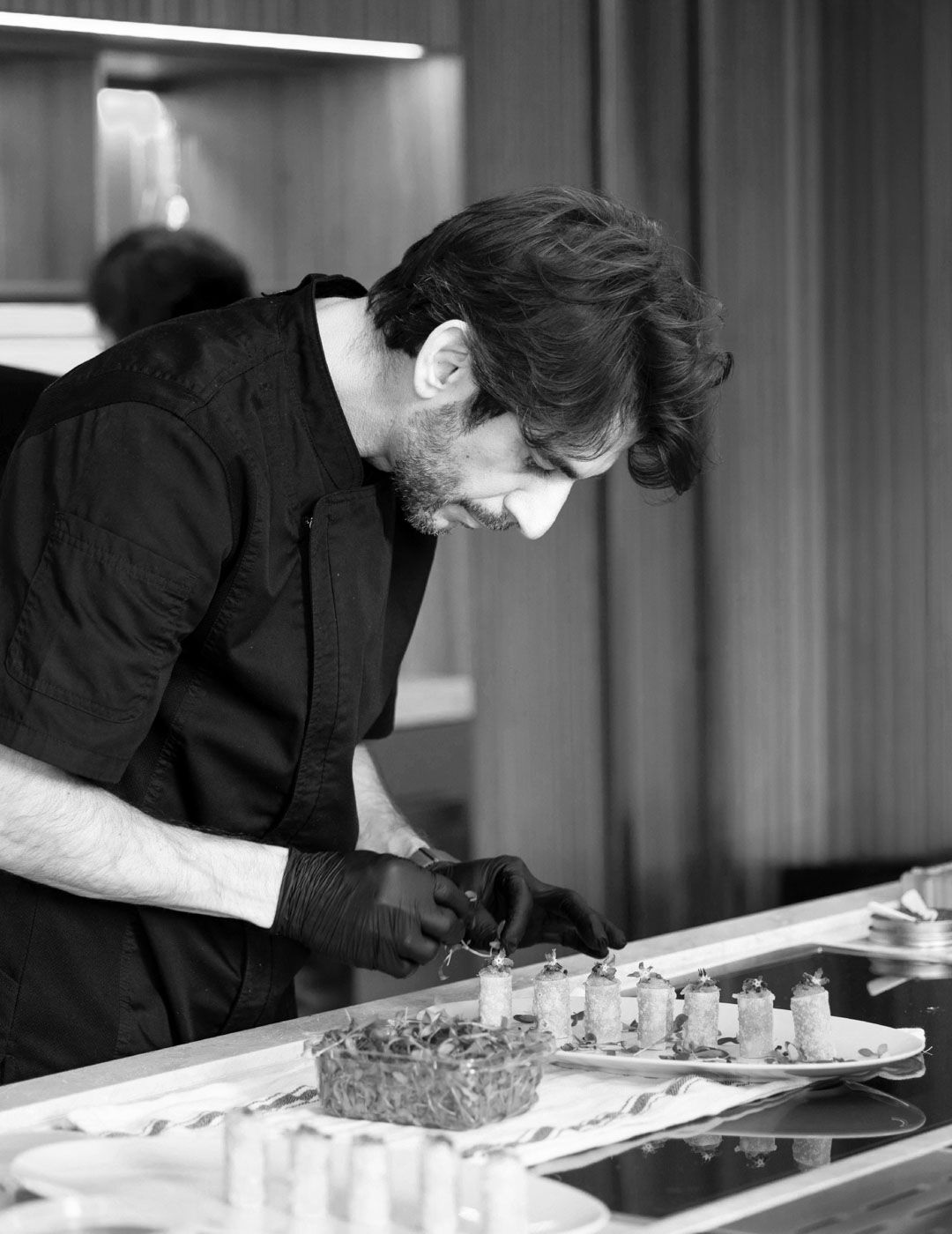 Chef preparing food in the Arclinea Proxima kitchen during showroom event