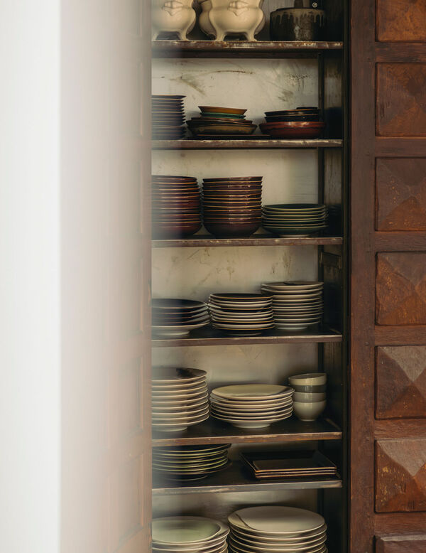Ceramic tableware storage beside Arclinea kitchen in restored London townhouse