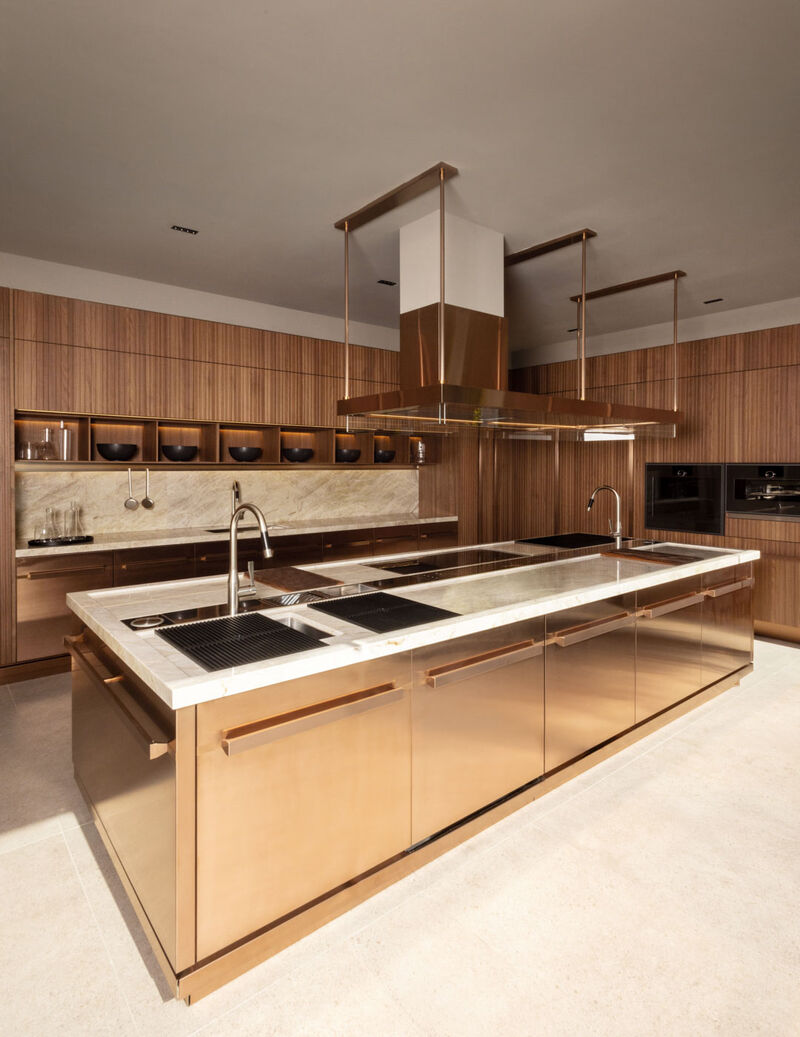Arclinea Proxima kitchen with bronze pvd island and suspended hood