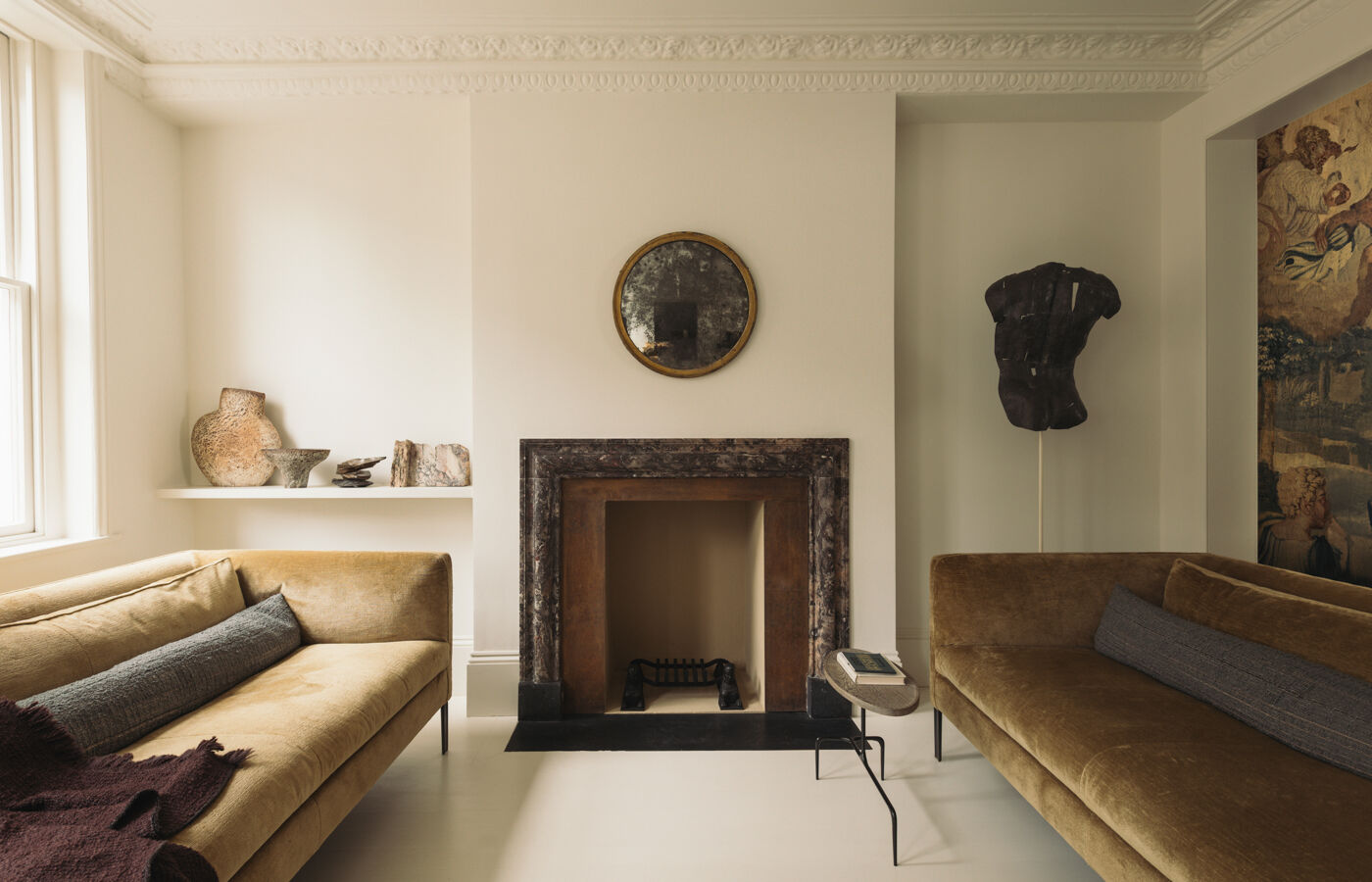 Elegant lounge with marble fireplace beside Arclinea kitchen in contemporary London townhouse