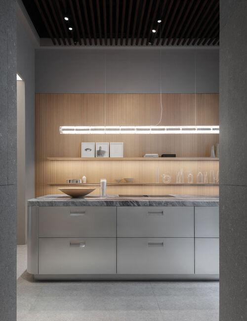 Arclinea kora kitchen with linear light in Milan showroom