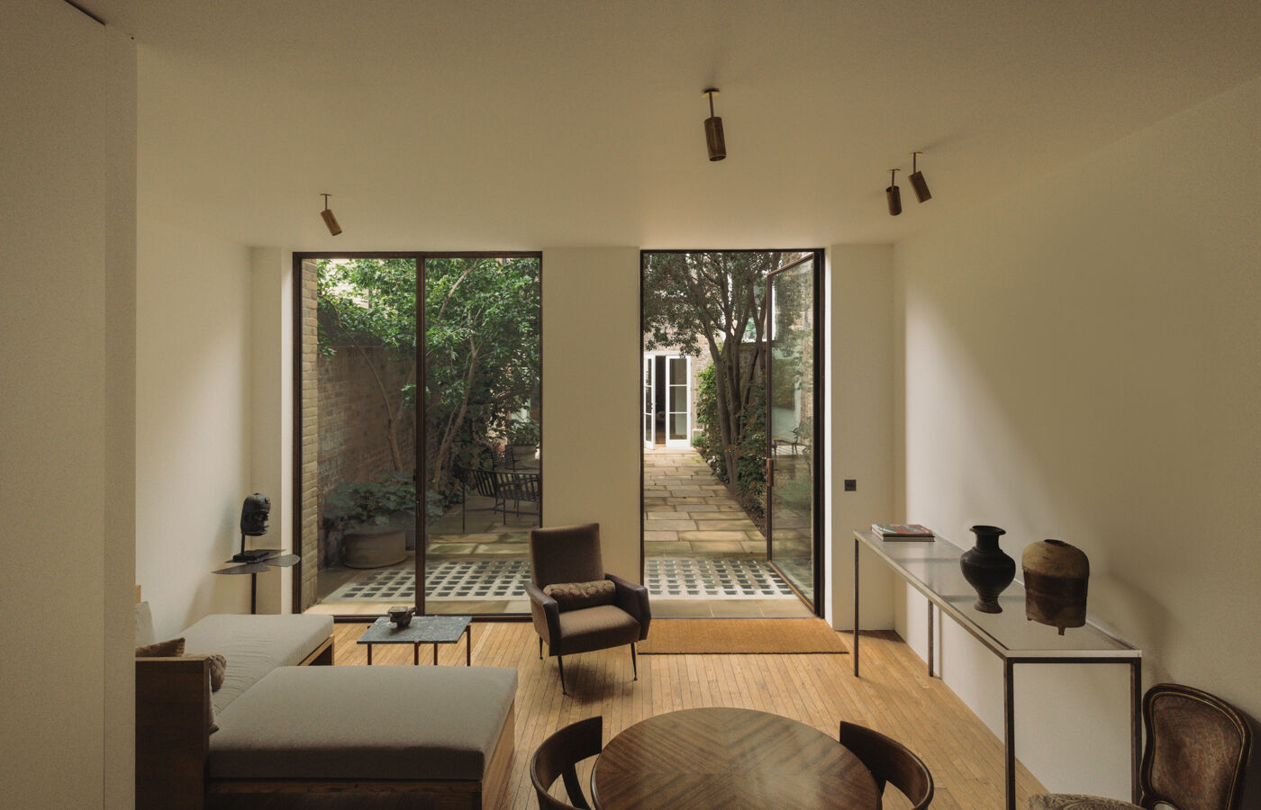 Contemporary lounge overlooking courtyard beside Arclinea kitchen in London home